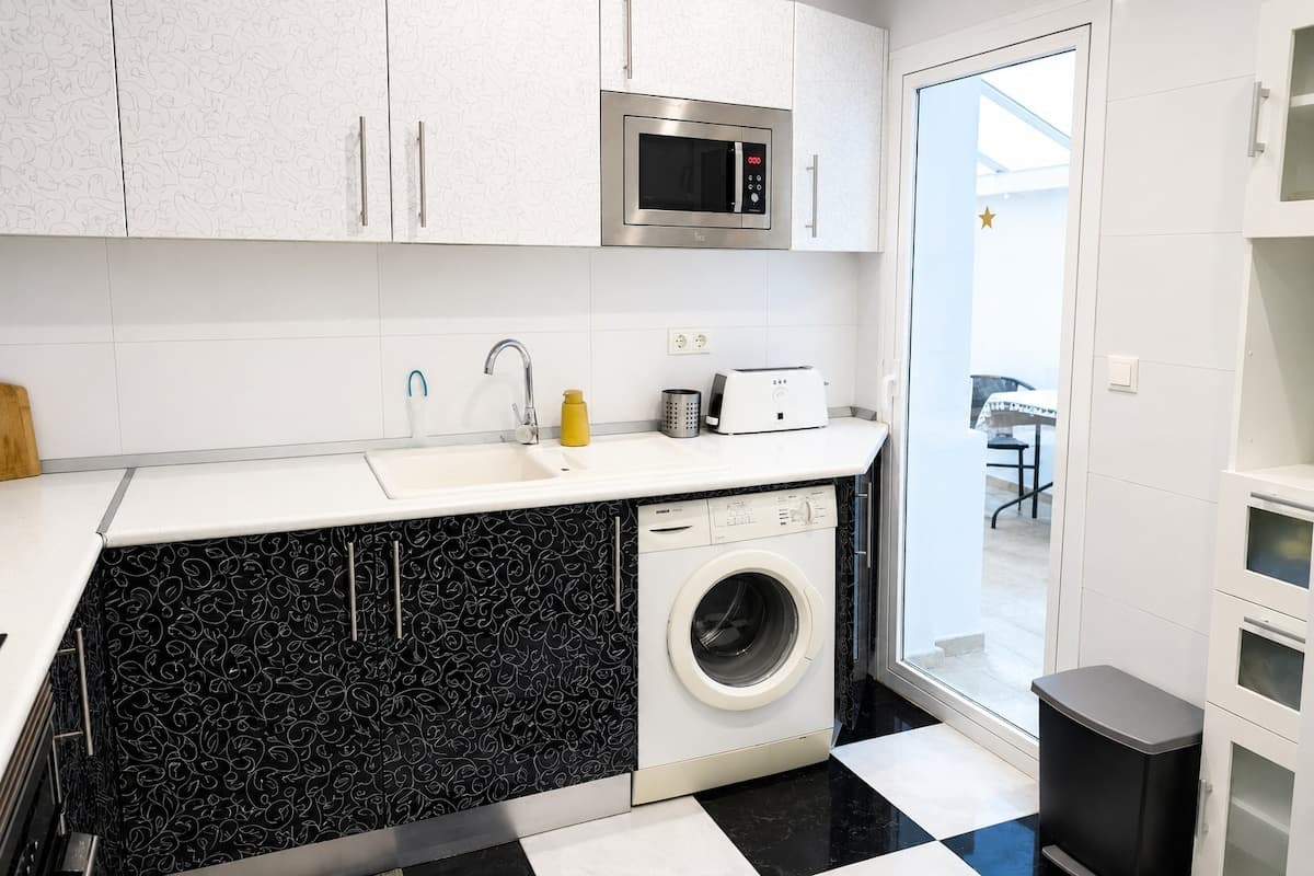 Kitchen with washer and terrace access